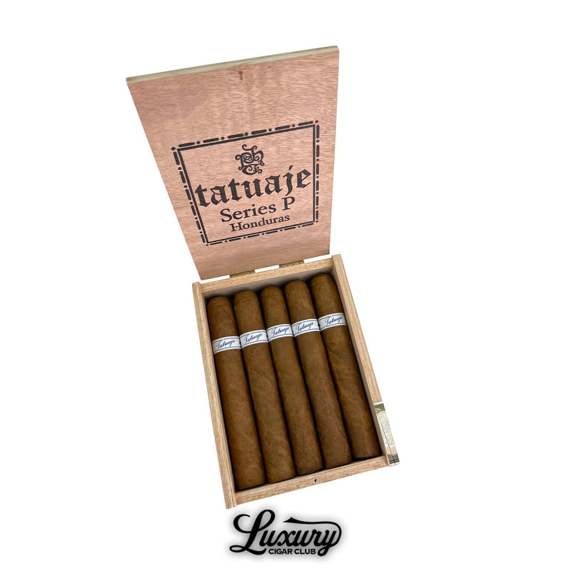 Open wooden box of Tatuaje Series P Honduras Short Toro cigars, 20 cigars neatly packed with white and blue Tatuaje bands, Luxury Cigar Club branding beneath.