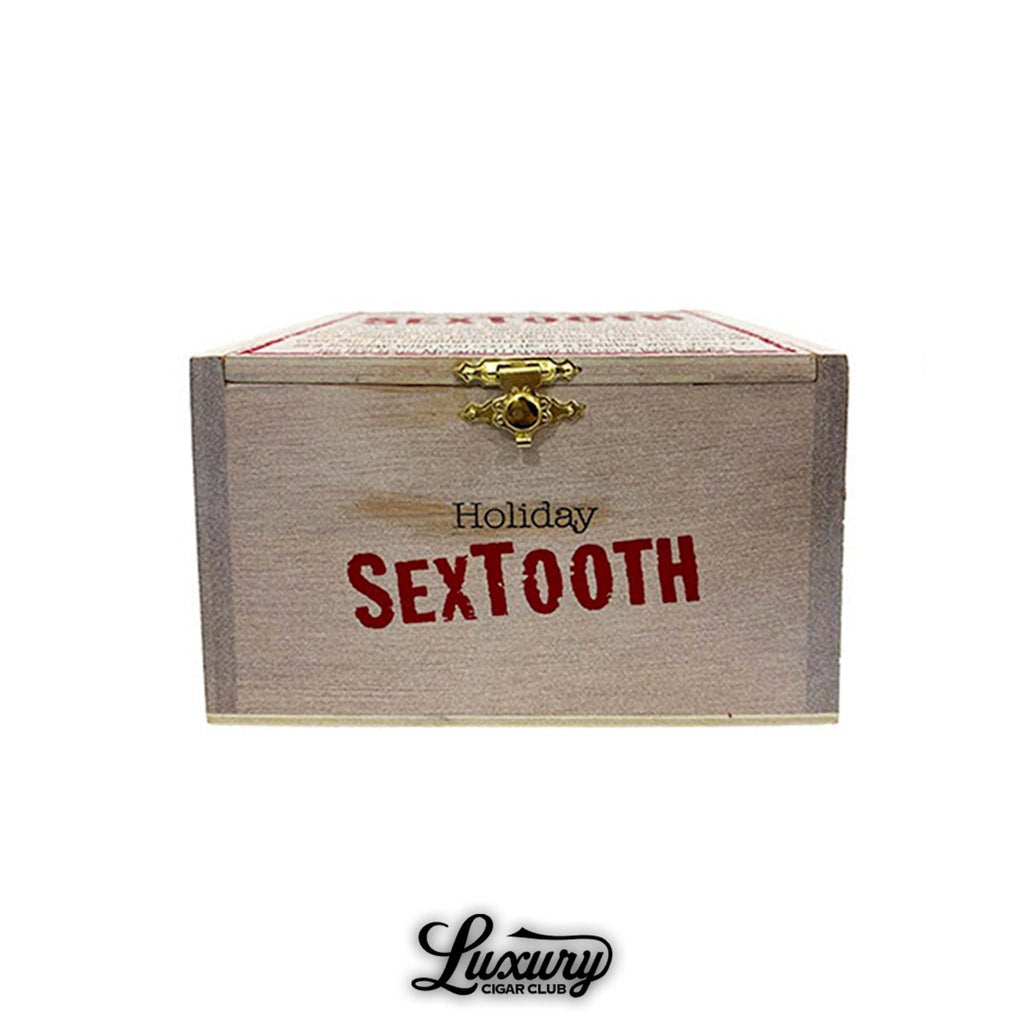 Tatuaje Holiday Sextooth wooden cigar box with red lettering and gold latch, presented by Luxury Cigar Club.