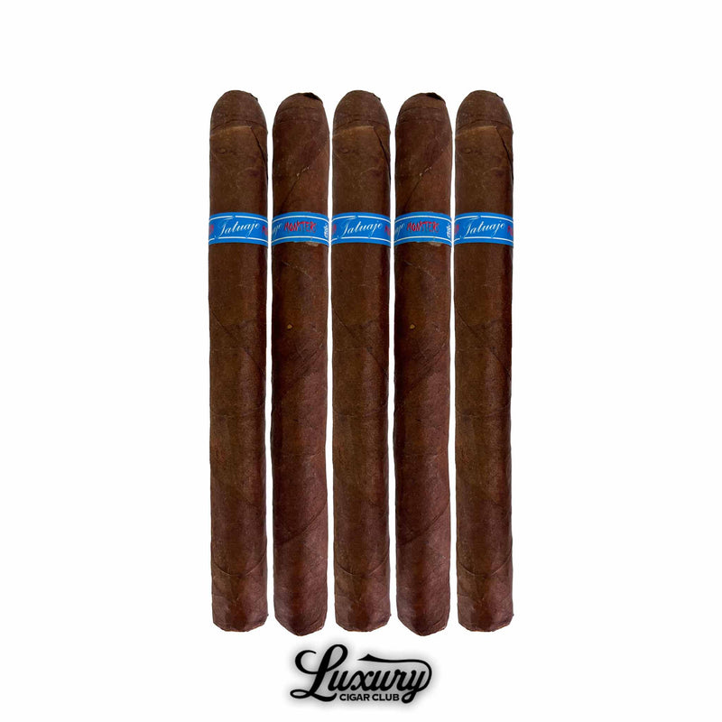 Five Tatuaje Skinny Monsters Chuck petit lancero cigars standing upright in a row, featuring dark brown wrappers and bright blue cigar bands with red lettering, displayed against a clean white background with the Luxury Cigar Club logo beneath them.