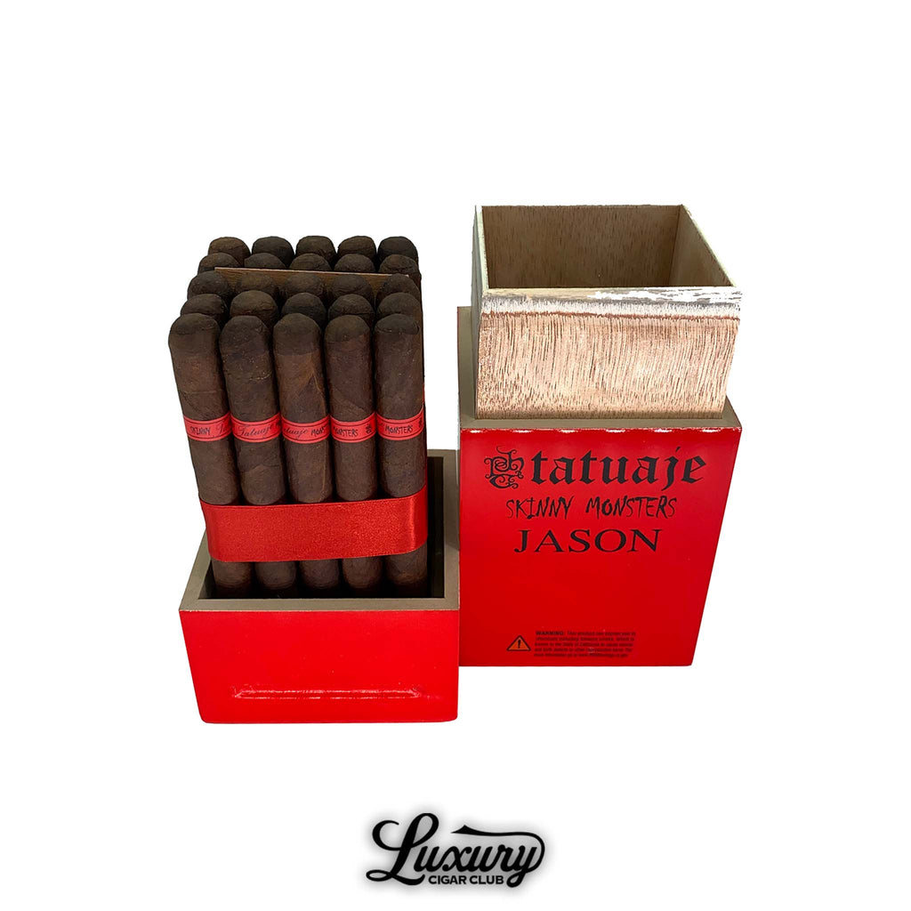 Open wooden Tatuaje Skinny Monsters Jason cigar box in bright red, showing a full bundle of dark brown petit lancero cigars neatly arranged inside, each with a red “Monsters” band and secured by a red ribbon, photographed on a clean white background with the Luxury Cigar Club logo below.