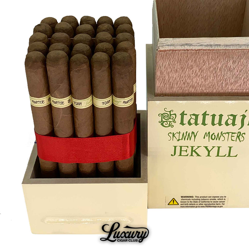 Close-up of Tatuaje Skinny Monsters Jekyll petit lancero cigars showing the smooth brown wrapper leaf, light green Jekyll cigar bands, and tight packing inside the Monster Series box.