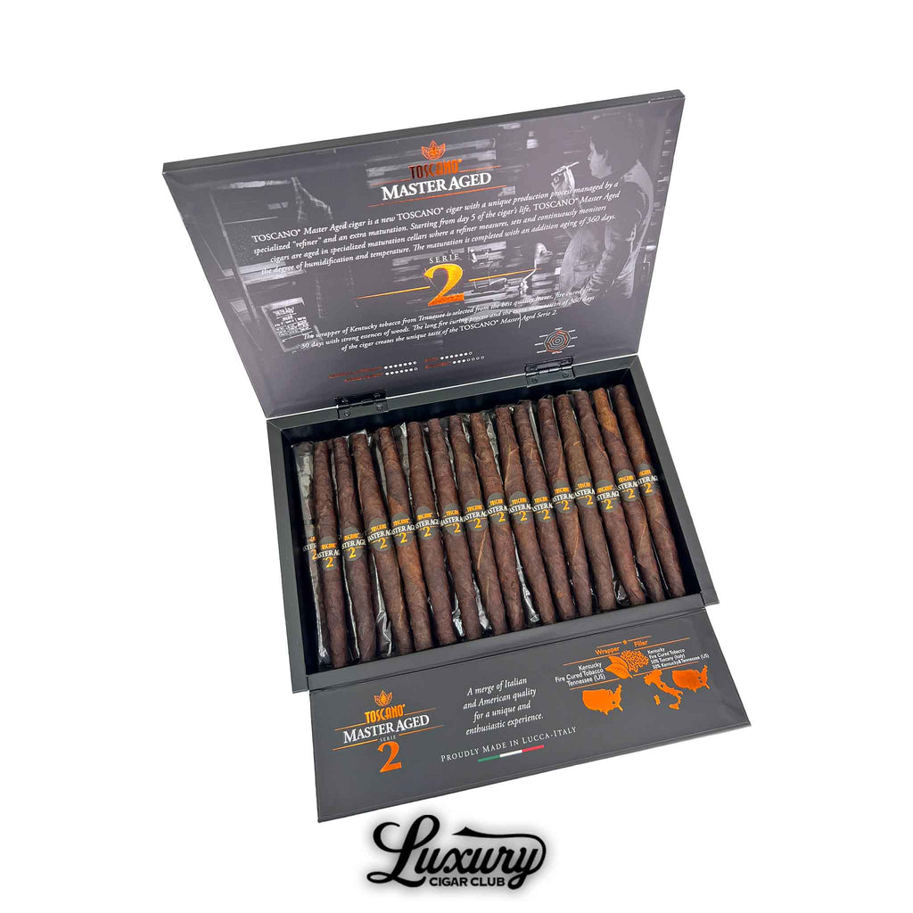 Open box of Toscano Master Aged Serie 2 cigars with rustic fire-cured wrappers neatly arranged, displayed with product details on the inner lid, photographed by Luxury Cigar Club.
