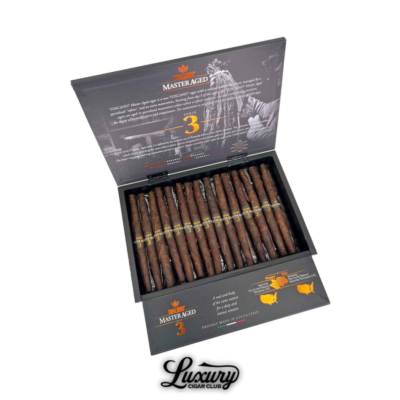 Open box of Toscano Master Aged Serie 3 cigars with long, dark fire-cured tobacco cigars displayed inside black packaging with silver and orange branding, available at Luxury Cigar Club.
