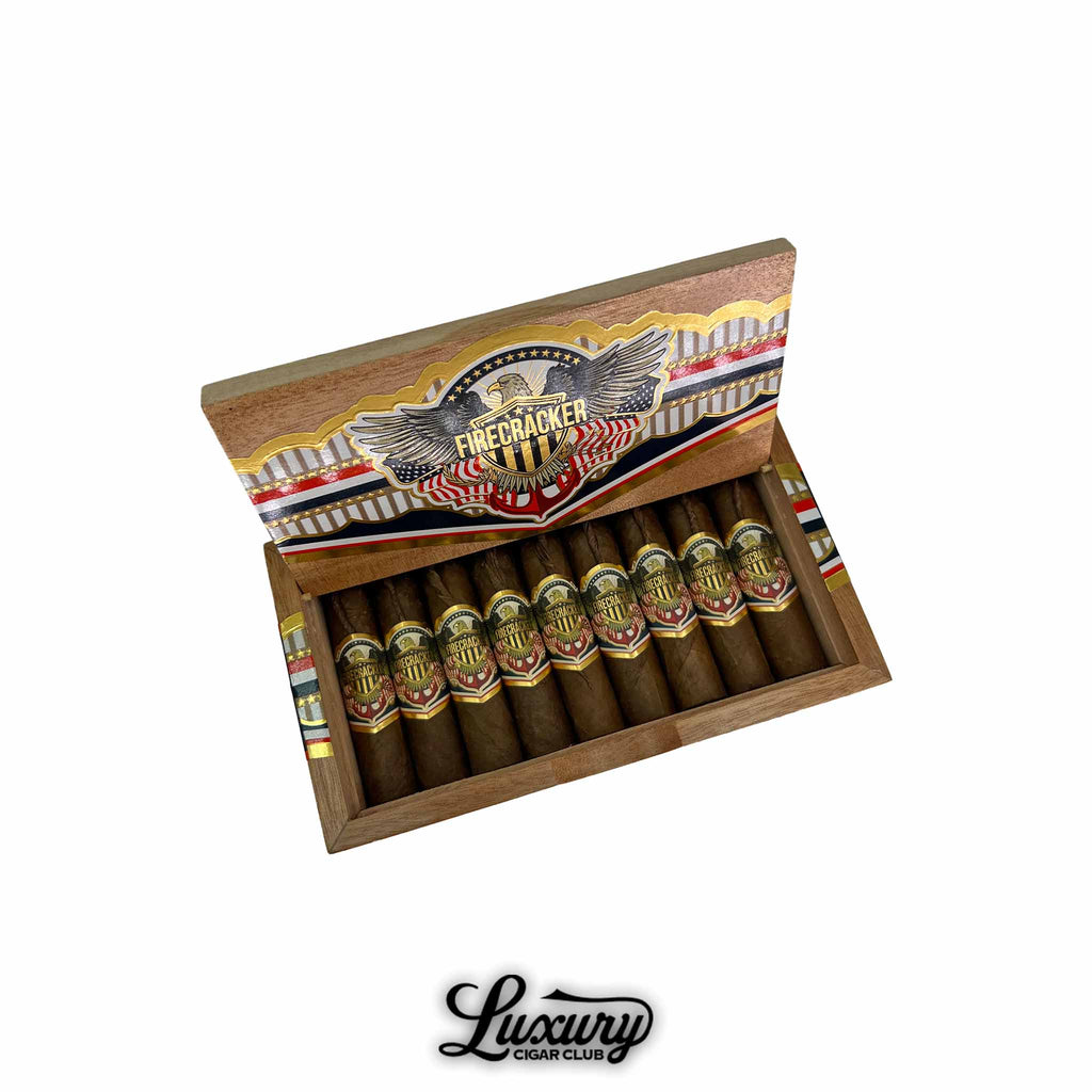 United Firecracker cigars in open box with patriotic-themed branding and gold accents, exclusive at Luxury Cigar Club.