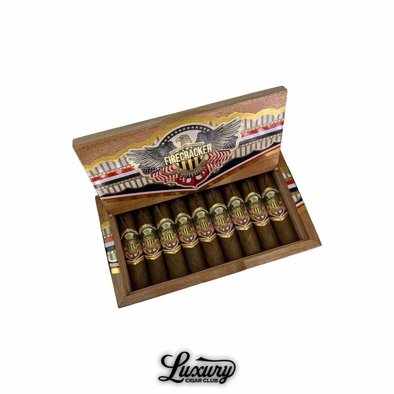 United Firecracker cigars in open box with patriotic-themed branding and gold accents, exclusive at Luxury Cigar Club.