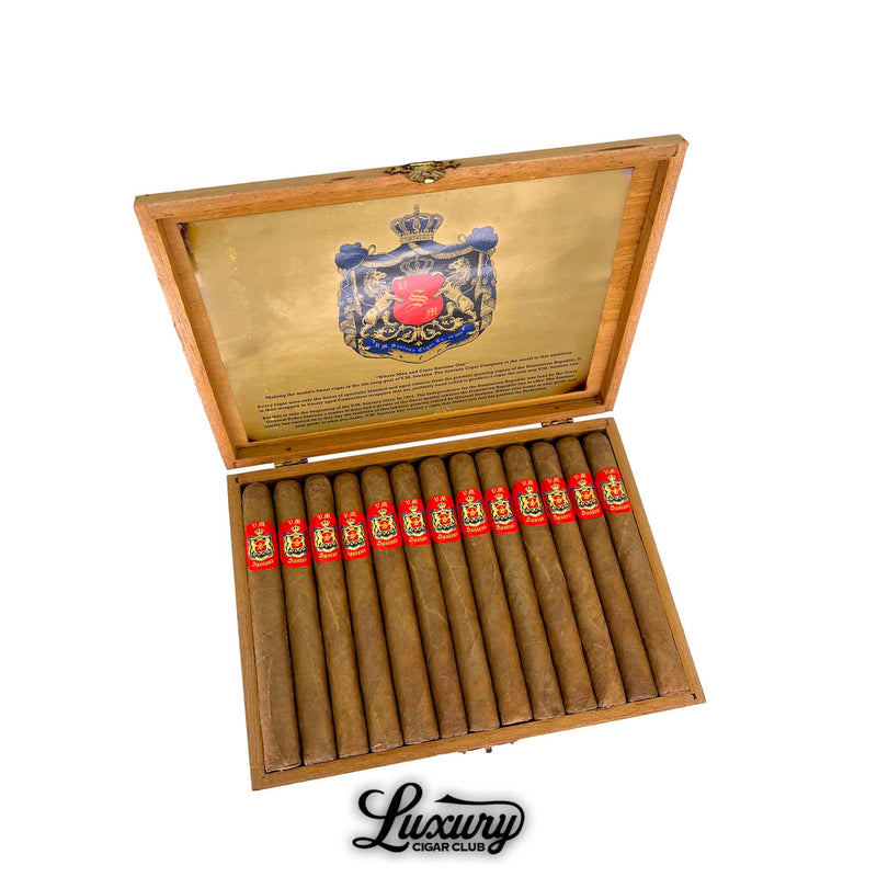 Luxury Cigar Club product photo showing an open wooden box of VM Santana Corona Connecticut USA Aged 29 Years cigars arranged in rows with bright red and gold cigar bands and a gold crest graphic on the inside lid.