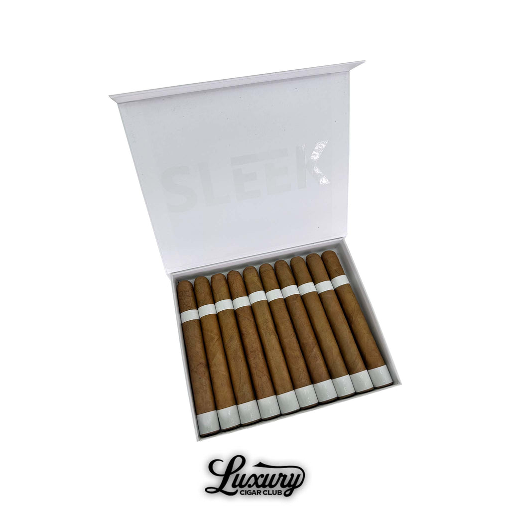 Open box of Vicente Blends Sleek White Churchill cigars featuring light brown wrappers and minimalist white bands. The lid displays the word “SLEEK” in faint white letters. Luxury Cigar Club logo below.