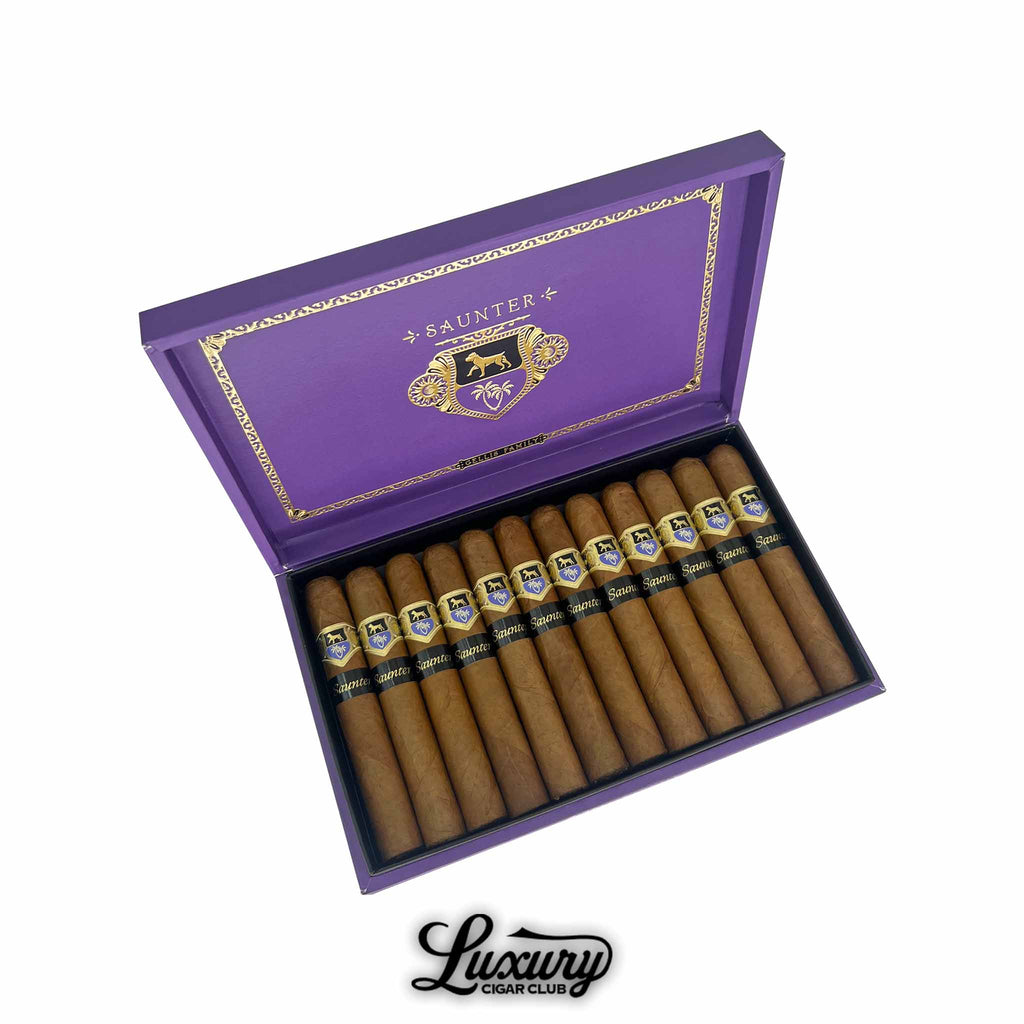 Open box of Warped Saunter cigars by Gellis Family Cigars, featuring a vibrant purple lid with gold detailing and a row of Connecticut-wrapped robusto cigars inside. Box labeled "Luxury Cigar Club."
