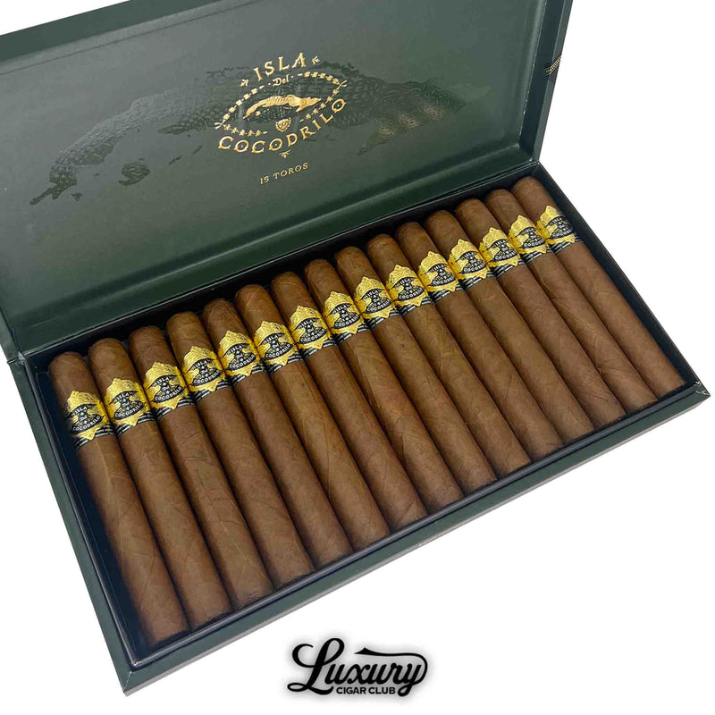 Close-up of Warped Isla Del Cocodrilo Toro cigars neatly arranged in a dark green box, each cigar adorned with a striking yellow and black band featuring crocodile imagery and gold accents.