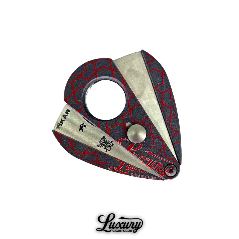 Exclusive double-blade cigar cutter with bold red geometric accents and Luxury Cigar Club logo.