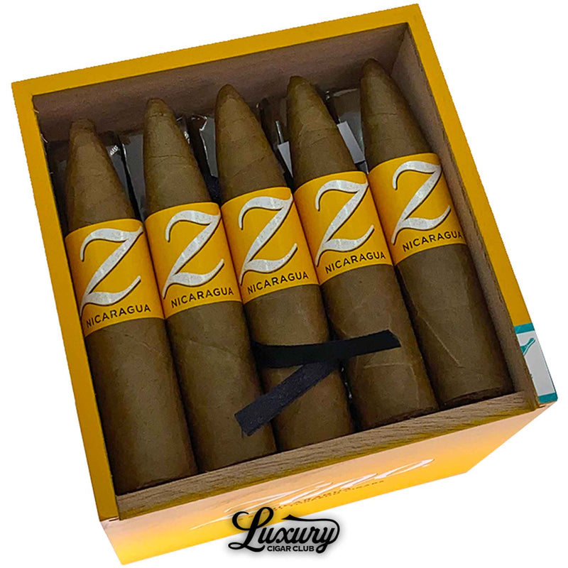 Close-up of Zino Nicaragua Short Torpedo cigars in a yellow box, highlighting golden brown wrappers and bold yellow branding at Luxury Cigar Club.